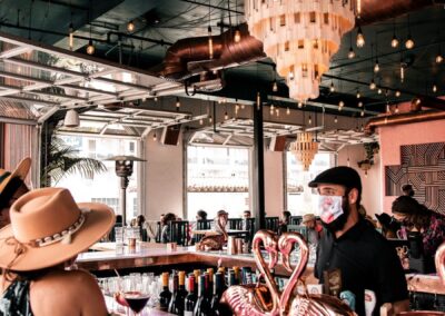 Bartender serving customers drinks at San Diego beachside restaurant